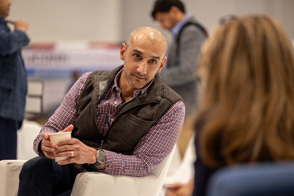 FiveM founder and CEO Miguel edwards having a conversation with an executive at a conference