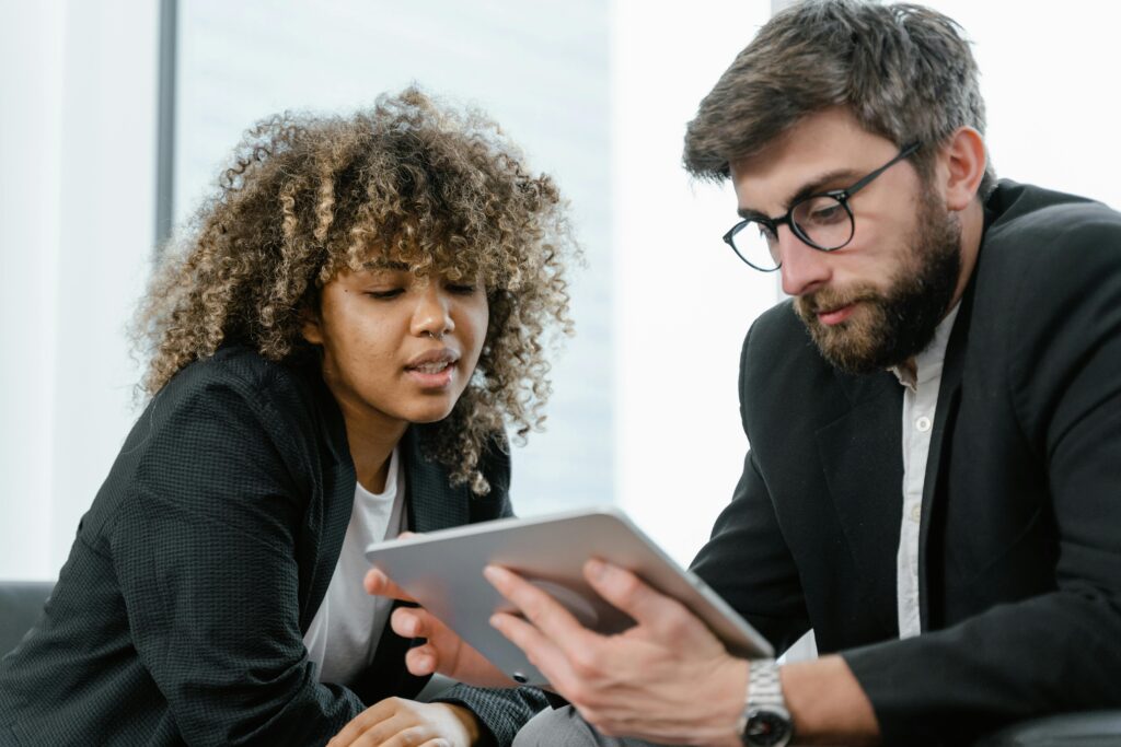 professional man and woman looking at digital screen